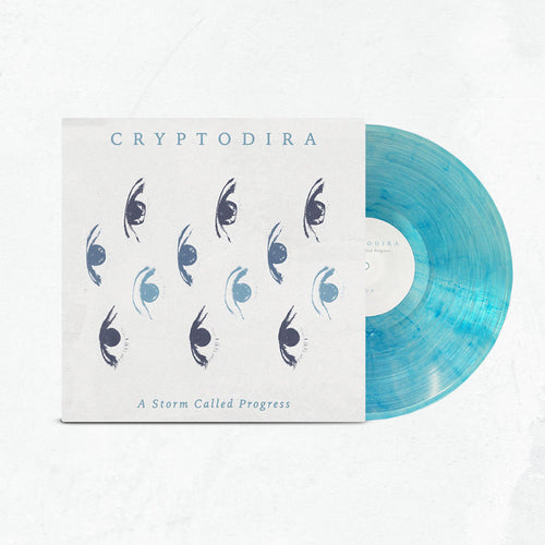 A limited edition light blue marbled vinyl, partially in its sleeve, displays Cryptodira’s name, abstract eye graphics, and the album title "A Storm Called Progress" on a white background.