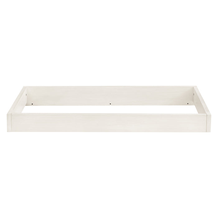 A white babyGap changing top designed to convert a dresser into a changing table.