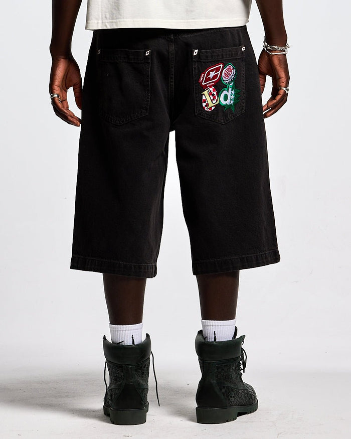 BADGES JORTS BLACK LICORICE - black baggy denim shorts, back view on male model - Cold Culture #man