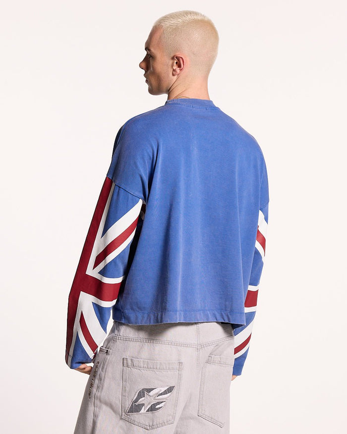 CHEERS LONGSLEEVE ROYAL - royal blue flag print longsleeve tee, back view on male model - Cold Culture #man