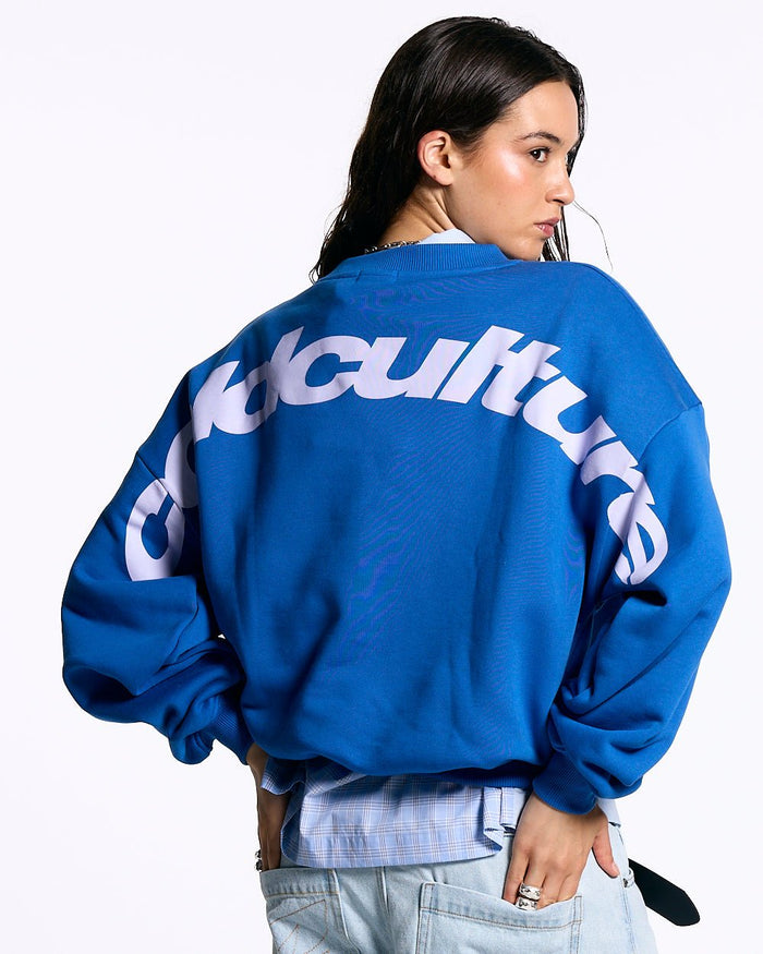 CURVED CREWNECK BLUE - blue oversized crewneck sweatshirt, back view on female model - Cold Culture #woman