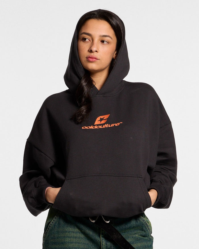 CURVED HOODIE BLACK - black logo print hoodie, front view on female model - Cold Culture #woman