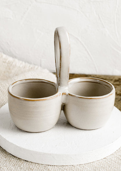 A double cellar ceramic vessel in off-white glaze.