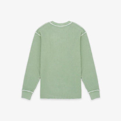 A sage green ribbed knit long-sleeve shirt with white contrast stitching on the shoulders, cuffs, and collar, shown flat against a light gray background.