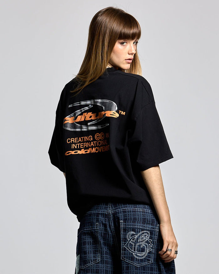DYNAMIC TEE BLACK AND ORANGE - black graphic print tee, back view on female model - Cold Culture #woman