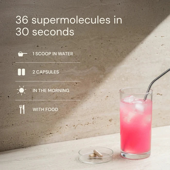 Glass of pink drink with a straw on a light surface, with text about supermolecules.
