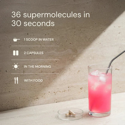 Glass of pink drink with a straw on a light surface, with text about supermolecules.