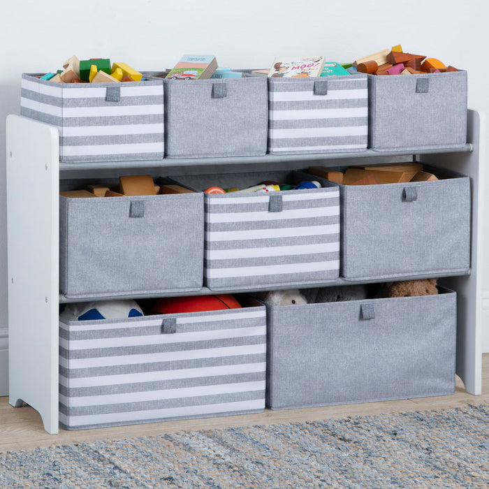Toy storage unit with gray bins and colorful toys on a light blue wall background