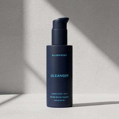 Blue bottle of Blueprint Cleanser on a light gray background