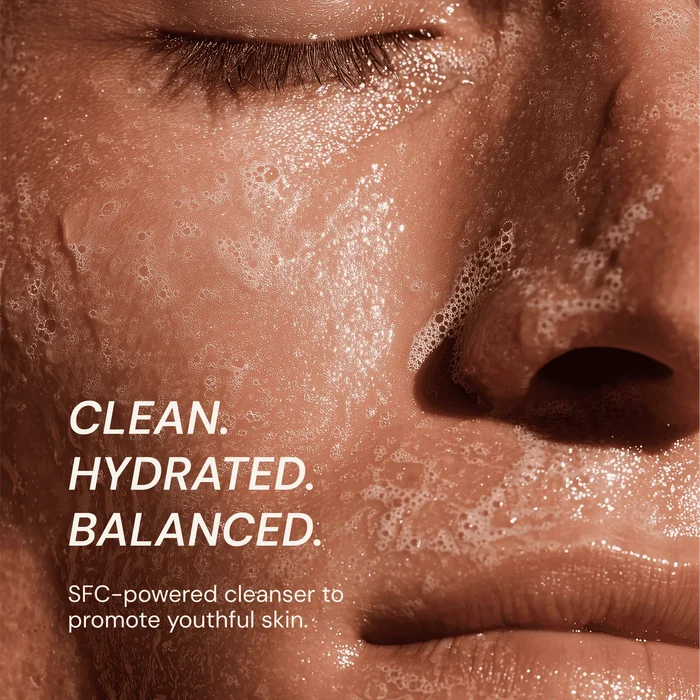 Close-up of a person's face with soap bubbles, text about cleanser benefits.