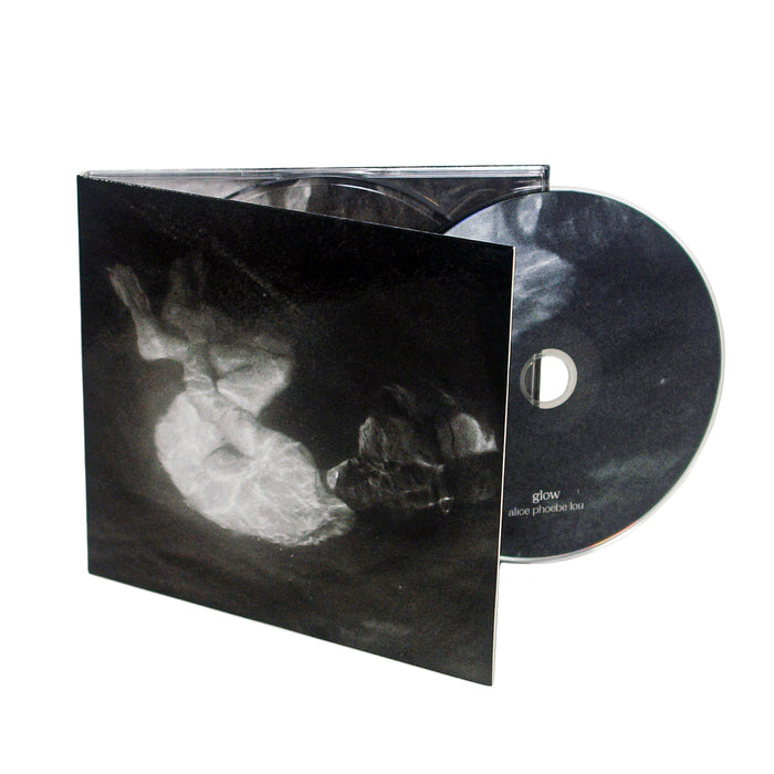 A CD partially removed from its case. The cover and CD feature a black and white abstract image. The CD is labeled glow Alice Phoebe Lou, marking her third album and a notable 2021 release.