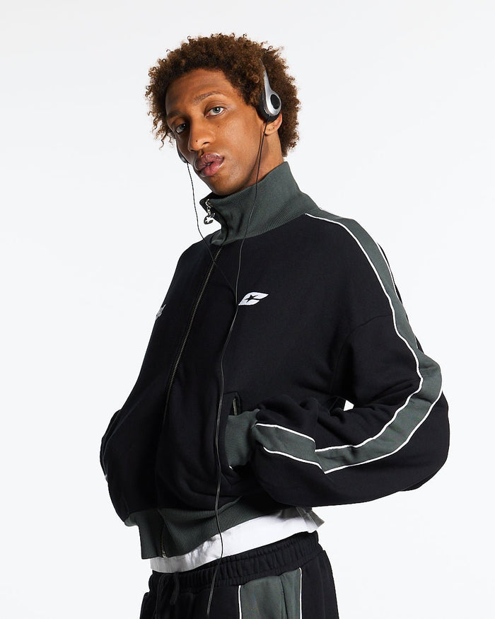 JET LAG JACKET BLACK - black and green zip-up hoodie, front view on male model - Cold Culture #man