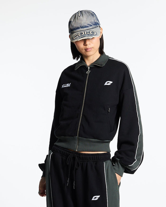 JET LAG JACKET BLACK - black and green zip-up hoodie, front view on female model - Cold Culture #woman