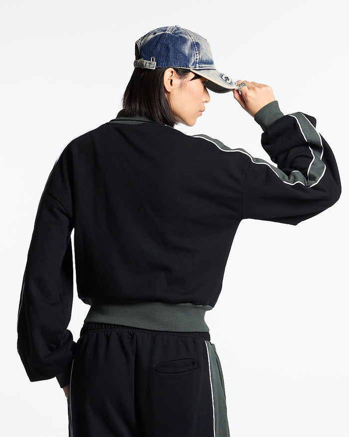JET LAG JACKET BLACK - black and green zip-up hoodie, back view on female model - Cold Culture #woman