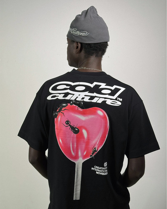 LOLLIPOP TEE BLACK - black graphic print tee, back view on male model - Cold Culture