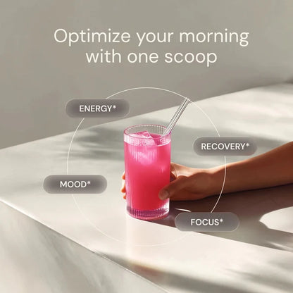 Hand holding a glass of pink drink with text about optimizing mornings and drink benefits.