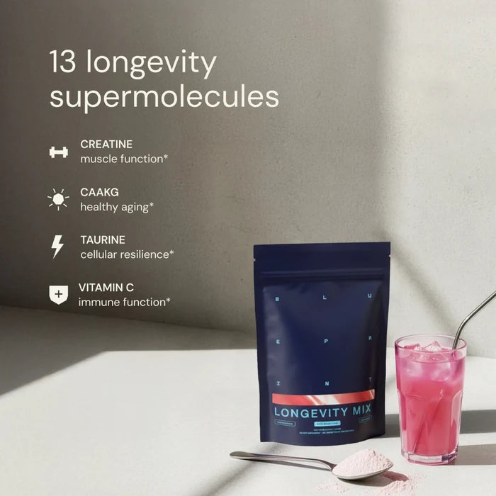 Longevity Mix powder package with a glass of pink drink on a light surface.