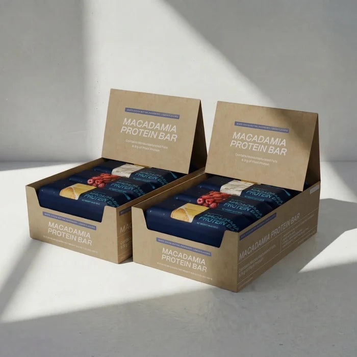 Two boxes of Macadamia Protein Bars on a light gray background