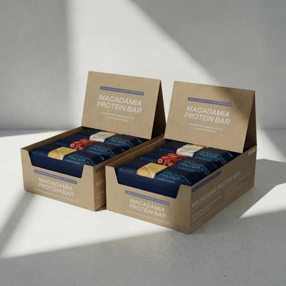 Two boxes of Macadamia Protein Bars on a light gray background