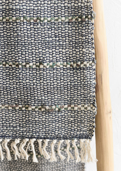 A blue and green table runner with stripe detail.