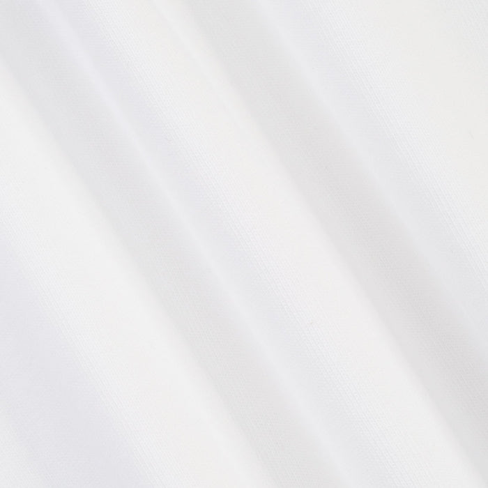 A close-up of a white textured fabric with soft diagonal folds and a fine woven pattern.
