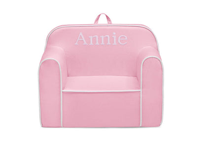 Pink children's chair with 'Annie' embroidered on a white background