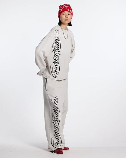 SCRIPT LONGSLEEVE TEE LIGHT GREY - light grey script print longsleeve tee, front view on female model - Cold Culture #woman