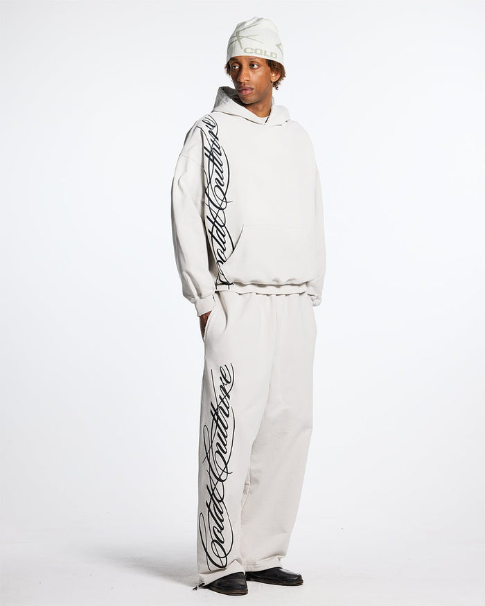 SCRIPT SWEATPANTS LIGHT GREY - light grey script print sweatpants, front view on male model - Cold Culture #man