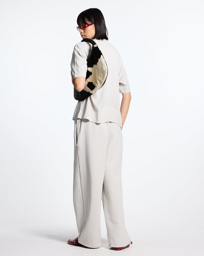 SCRIPT SWEATPANTS LIGHT GREY - light grey script print sweatpants, back view on female model - Cold Culture #woman