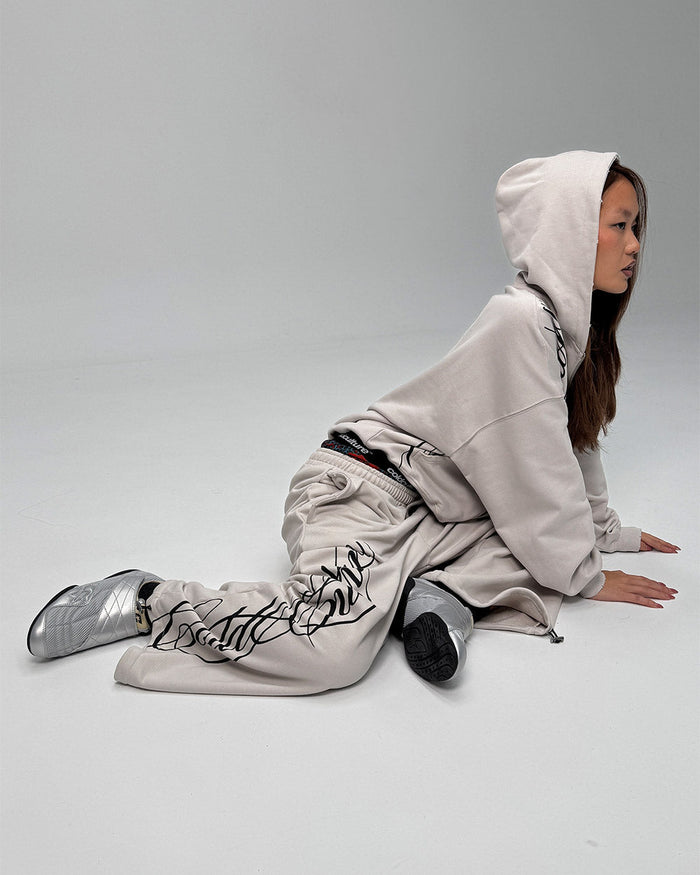 SCRIPT SWEATPANTS LIGHT GREY - light grey script print sweatpants, street style shot - Cold Culture