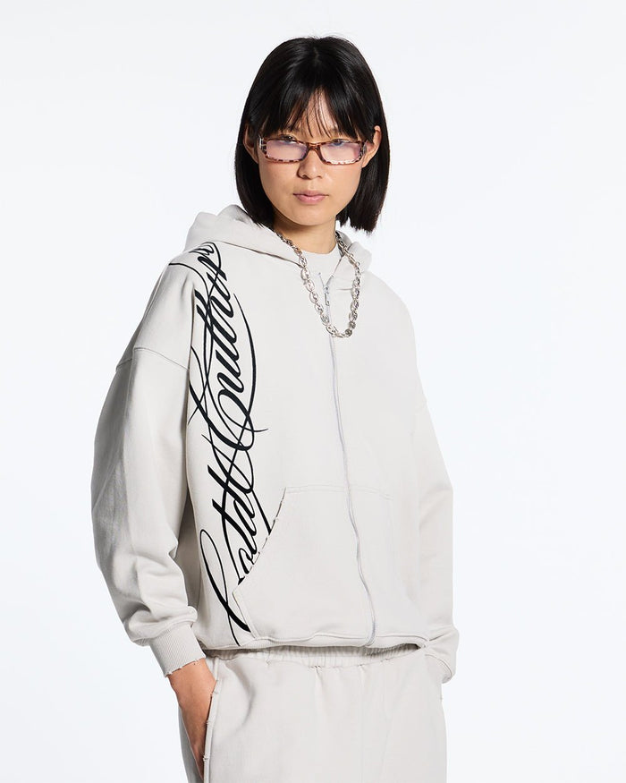 SCRIPT ZIP HOODIE LIGHT GREY - light grey script print zip hoodie, front view on female model - Cold Culture #woman