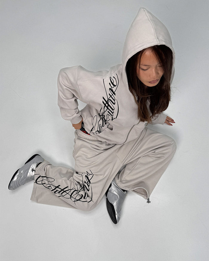 SCRIPT ZIP HOODIE LIGHT GREY - light grey script print zip hoodie, street style shot - Cold Culture