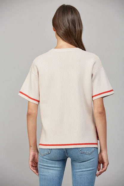 cream knit sweater top with orange stripe detail