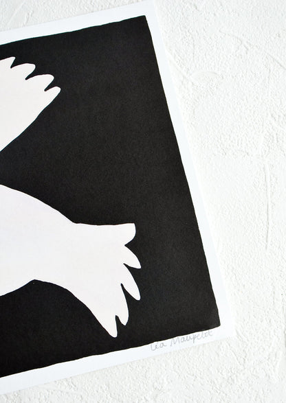 Artist's signature on corner of black and white art print.